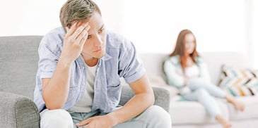fighting couple sitting a distance apart 