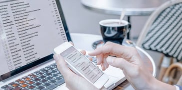 person using computer and phone at same time
