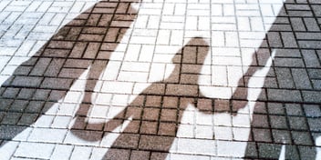 shadow image of two parents holding child hand