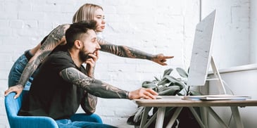 couple reading computer screen together