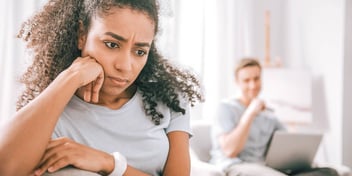 woman with chin in hands because she is unhappy with man