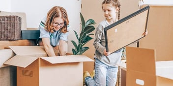 mom and child unpacking boxes new home
