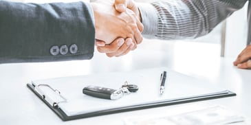 hands shaking over a clipboard and keys