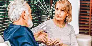 older man speaking to older woman