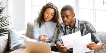 couple huddled around computer 