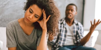 man is yelling while woman looks away
