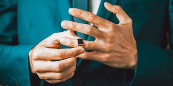 man removing wedding band