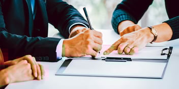 man and woman signing official documents