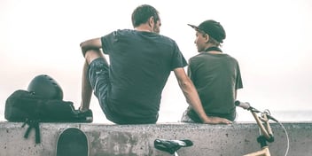 dad and son resting after a bike ride
