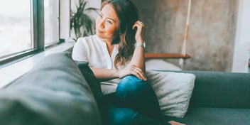 woman thinking about her life on a couch