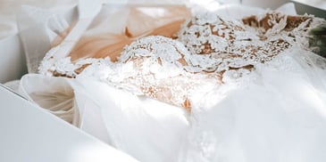 closeup view of lacy wedding dress in box