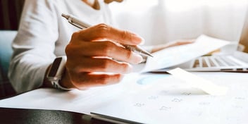 man writing on paper