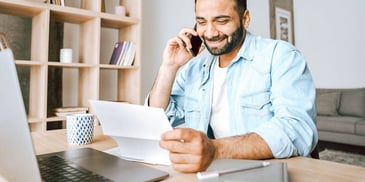 man holding divorce decree and smiling