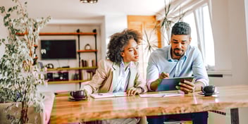 couple sitting together at table working on forms