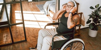 woman in wheelchair listening to music