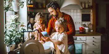 dad and twin girls in apartment kitchen