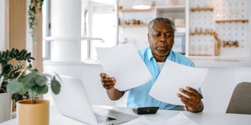 man looking at papers