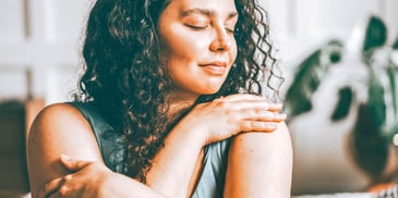 single woman looks thoughtful with eyes lowered