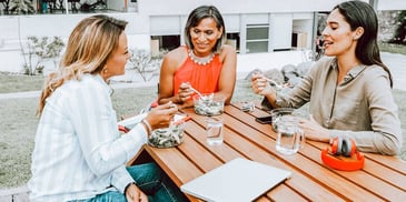 three moms gathered around a table