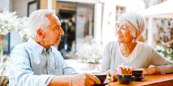 older couple at lunch table smiling