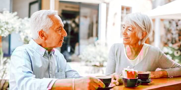 older couple at lunch table smiling