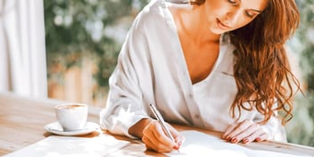 woman writing on paper