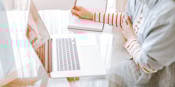 taking notes at computer