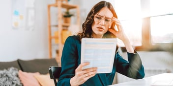 woman confused looking at papers