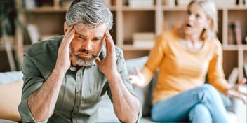 unhappy couple with man holding head in hands