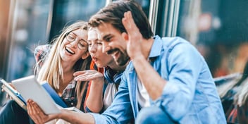 happy dad laughing with two teen daughters