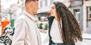 couple standing outside arguing with each other