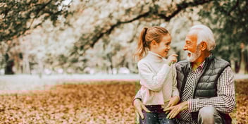 grandfather and granddaughter outside by autumn mountain