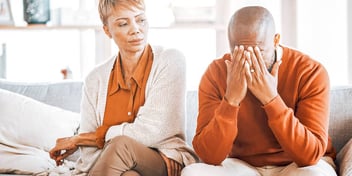 annoyed woman sits next to man