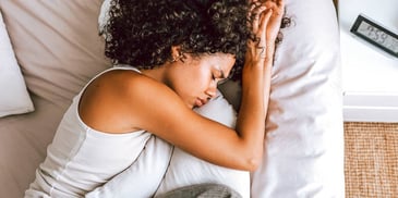 woman asleep on white bedding