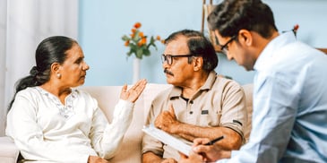 couple on couch tense conversation with mediator