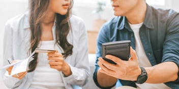 couple calmly discussing their breakup with calculator