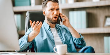 upset man talking on phone and gesturing