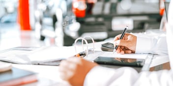 hand writing in notebook at desk