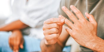 man removing wedding band