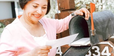 smiling woman holding paper