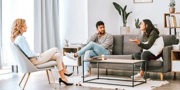 angry couple fighting during mediation or therapy