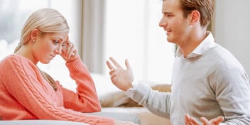 man and woman arguing in their living room