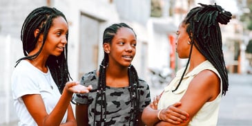 mother and her two teen daughters having a conversation