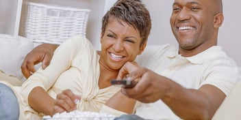 couple watching a movie together on the couch
