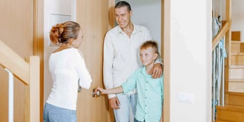 Man and child arriving to meet women at home