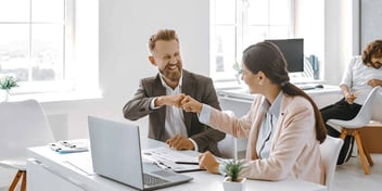 coworkers shaking hands in an office