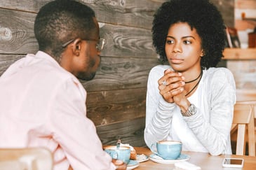 couple having a calm discussion at a cafe
