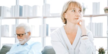 distracted woman daydreaming next to her husband