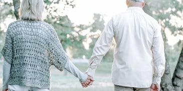 man and woman walking hand in hand