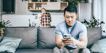 couple ignoring each other at home
